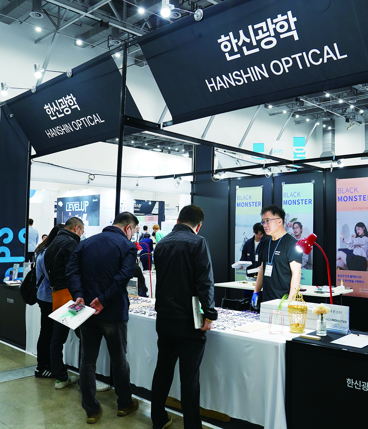한신광학 부스에서 바이어들이 블랙몬스터 제품을 살펴보고 있다.